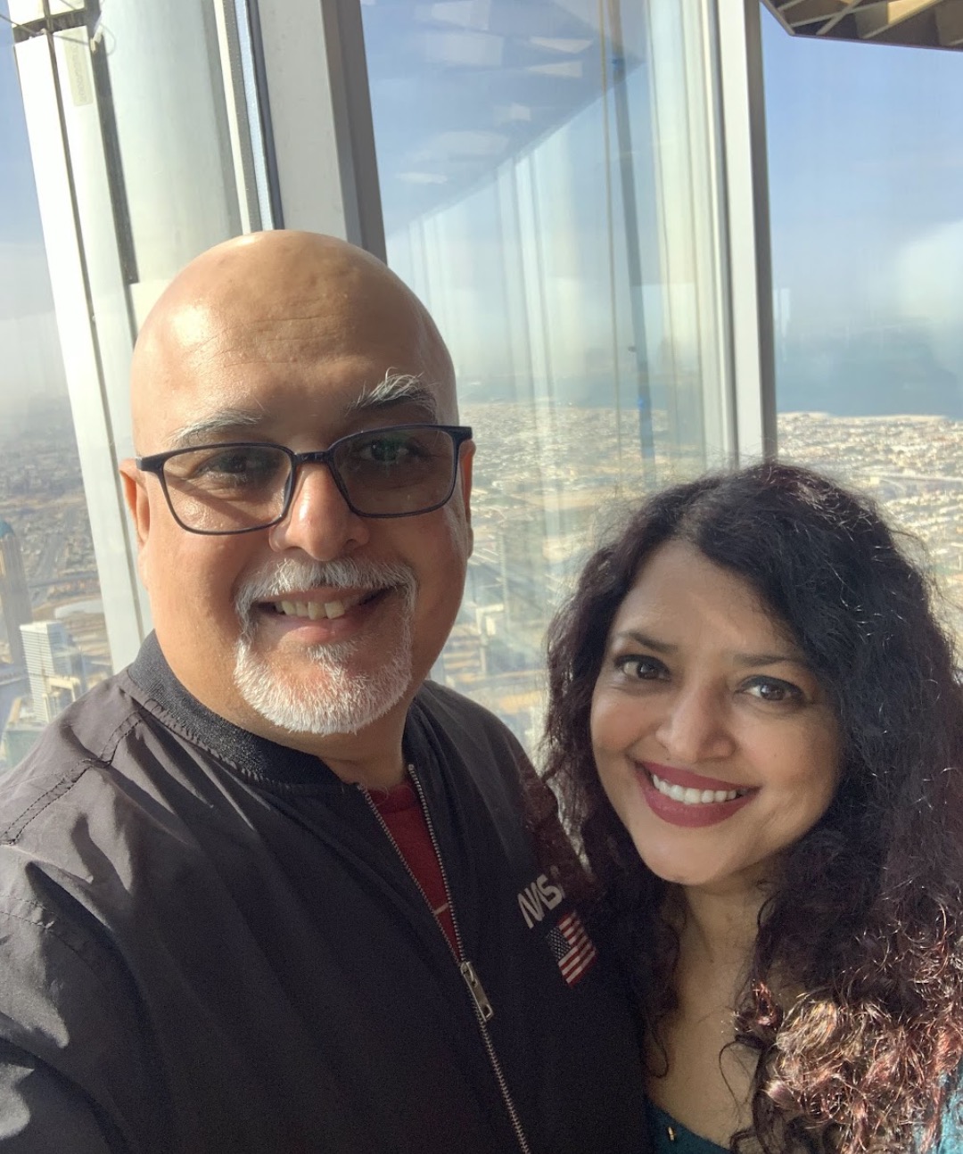 Hemant and Dr. Neha at a panoramic city-skyline observation deck - light, candid, real